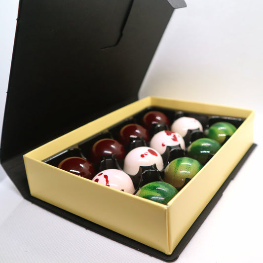 Three-quarters shot of open black handmade chocolate bonbon box by dark desires