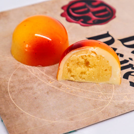 Cross-section of orange mango luxury handmade chocolate bonbons  by Dark Desires